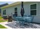 Outdoor patio with metal table and chairs, grill, and rug, perfect for entertaining or relaxing at 250 Winford Rd, Troutman, NC 28166