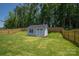 Well-maintained storage shed in a fenced backyard, offering ample space for outdoor equipment and tools at 250 Winford Rd, Troutman, NC 28166