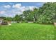 Expansive backyard featuring lush green grass, mature trees, and a well-maintained lawn on a bright, sunny day at 2525 Saddlehorse Ln, Gastonia, NC 28056