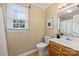 Well-lit bathroom featuring a single sink vanity, neutral paint, and a window bringing in natural light at 2525 Saddlehorse Ln, Gastonia, NC 28056