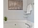 Close up shot of tub with chrome faucet, small shelves and decorative wall art at 2525 Saddlehorse Ln, Gastonia, NC 28056
