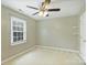 Empty bedroom with neutral walls, carpet, ceiling fan, and large window at 2525 Saddlehorse Ln, Gastonia, NC 28056