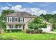 Charming two-story home with a well-manicured lawn, mature landscaping, and a welcoming front porch at 2525 Saddlehorse Ln, Gastonia, NC 28056