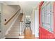 Inviting foyer with hardwood floors, staircase, and a glimpse into the dining area through the doorway at 2525 Saddlehorse Ln, Gastonia, NC 28056