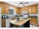 Traditional kitchen featuring wood cabinetry, black countertops, island and modern appliances at 2525 Saddlehorse Ln, Gastonia, NC 28056