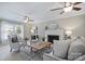 Bright living room with a fireplace, neutral carpet, ceiling fan, and a sliding glass door at 2525 Saddlehorse Ln, Gastonia, NC 28056