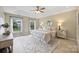 Spacious main bedroom with tray ceiling, carpet, two windows and decorative furniture at 2525 Saddlehorse Ln, Gastonia, NC 28056