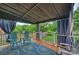 Covered patio with outdoor seating, a blue rug, and decorative curtains for privacy and shade at 2525 Saddlehorse Ln, Gastonia, NC 28056