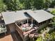 An aerial view of the back of the home highlighting the outdoor deck with plush seating at 26 New River Trce, Lake Wylie, SC 29710