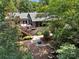 Charming backyard featuring a deck with outdoor seating, a fire pit, and wooded landscape at 26 New River Trce, Lake Wylie, SC 29710