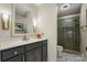 Bathroom with a granite vanity, stylish mirror and a glass door shower at 26 New River Trce, Lake Wylie, SC 29710