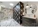 Stylish bathroom showcasing marble floors, patterned accent wall, and a luxurious walk-in shower at 26 New River Trce, Lake Wylie, SC 29710