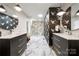Modern bathroom featuring marble floors, dual vanities, and a spacious glass-enclosed shower at 26 New River Trce, Lake Wylie, SC 29710