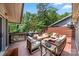 Comfortable wooden deck with outdoor seating, grill, and wooded view at 26 New River Trce, Lake Wylie, SC 29710