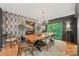 A dining room showcasing a unique wooden table, an elegant light fixture, and eclectic wallpaper at 26 New River Trce, Lake Wylie, SC 29710
