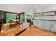Open concept with dining area, featuring a dining table, hardwood floors, and an adjacent kitchen area at 26 New River Trce, Lake Wylie, SC 29710