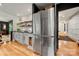 Modern kitchen featuring stainless steel refrigerator, white cabinets, and a view into dining room at 26 New River Trce, Lake Wylie, SC 29710