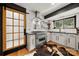 Modern kitchen with stainless steel appliances, white tile backsplash, and hardwood floors with a sliding barn door at 26 New River Trce, Lake Wylie, SC 29710