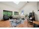 Bright living room boasts vaulted ceilings, skylight, hardwood floors, and ample natural light through expansive windows at 26 New River Trce, Lake Wylie, SC 29710