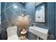 Stylish powder room featuring modern fixtures, striking wallpaper, and elegant decor at 26 New River Trce, Lake Wylie, SC 29710