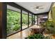 Bright sunroom with hardwood floors, scenic views of lush backyard, and access to the outdoor patio at 26 New River Trce, Lake Wylie, SC 29710