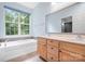 Light and airy bathroom with a double sink vanity, large window and a soaking tub at 2695 Queens Rd, Lincolnton, NC 28092