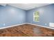 Bedroom featuring hardwood floors, blue walls and a window providing natural light at 2695 Queens Rd, Lincolnton, NC 28092