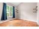 Bedroom with hardwood floors and a large window providing natural light at 2695 Queens Rd, Lincolnton, NC 28092