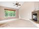 Carpeted primary bedroom with fireplace and large windows at 2695 Queens Rd, Lincolnton, NC 28092