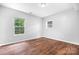 Empty bedroom featuring hardwood flooring, a double window, and neutral paint at 2695 Queens Rd, Lincolnton, NC 28092