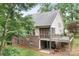 View of the back exterior featuring brick walls, deck, and screened in porch at 2695 Queens Rd, Lincolnton, NC 28092