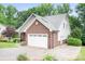 Exterior view of the home featuring a brick and vinyl siding with a two car garage at 2695 Queens Rd, Lincolnton, NC 28092