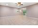 Spacious living room with tiled flooring, ceiling fan and sliding glass door to the outside at 2695 Queens Rd, Lincolnton, NC 28092