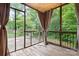 Screened porch with wood flooring, railings, and outdoor views at 2695 Queens Rd, Lincolnton, NC 28092