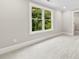 Bright bedroom with a large window offering views of the lush greenery outside at 2857 Scarborough Ct, Gastonia, NC 28054