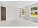 Bright bedroom features dual windows, plush carpet, and a walk-in closet at 2857 Scarborough Ct, Gastonia, NC 28054
