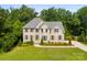 Beautiful two-story brick home with a manicured lawn and mature trees at 2857 Scarborough Ct, Gastonia, NC 28054