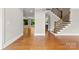 Inviting foyer with gleaming hardwood floors, open floor plan and a staircase with decorative metal spindles at 2857 Scarborough Ct, Gastonia, NC 28054
