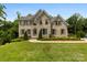 Beautiful two-story brick home featuring manicured landscaping, shutters, and a well-maintained lawn at 2857 Scarborough Ct, Gastonia, NC 28054