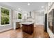 Bright kitchen features white cabinets, stainless appliances and a kitchen island at 2857 Scarborough Ct, Gastonia, NC 28054