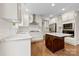 Kitchen features white cabinets, stainless appliances, gas range, kitchen island and granite countertops at 2857 Scarborough Ct, Gastonia, NC 28054