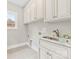 Well-organized laundry room with granite countertops and ample cabinet space at 2857 Scarborough Ct, Gastonia, NC 28054