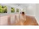 Bright room featuring hardwood floors, many windows, open floorplan to kitchen with island and modern appliances at 2857 Scarborough Ct, Gastonia, NC 28054