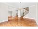 Spacious living room featuring hardwood floors, staircase and chandelier, perfect for entertaining at 2857 Scarborough Ct, Gastonia, NC 28054