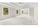 Large main bedroom with tray ceiling, recessed lighting, and abundant natural light from large windows at 2857 Scarborough Ct, Gastonia, NC 28054