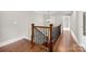 Stairway with wood railings and iron spindles is illuminated by decorative light fixture at 2857 Scarborough Ct, Gastonia, NC 28054