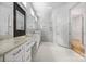 Luxurious bathroom with double vanity, granite counters, glass shower, and tile flooring at 3008 Laney Pond Rd, Matthews, NC 28104