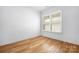 Bright bedroom with hardwood floors and natural light from a window at 3008 Laney Pond Rd, Matthews, NC 28104