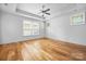 Bright bedroom with hardwood floors, ceiling fan, and ample natural light from windows at 3008 Laney Pond Rd, Matthews, NC 28104
