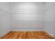 Walk-in closet with built-in shelving, hardwood floor, and white trim at 3008 Laney Pond Rd, Matthews, NC 28104